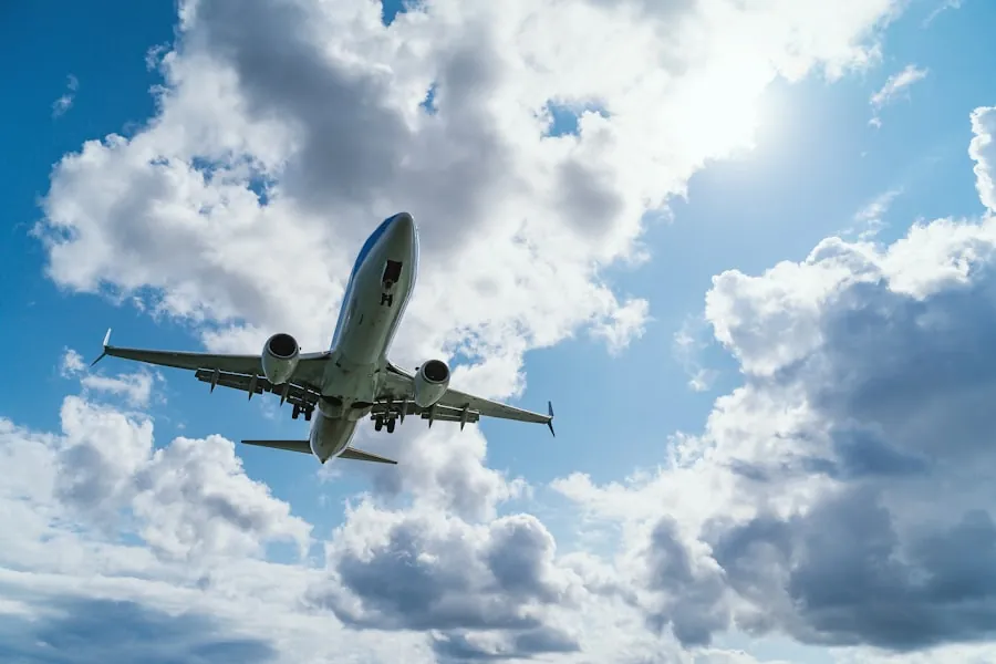 An airliner climbing into a blue, cloud-filled sky